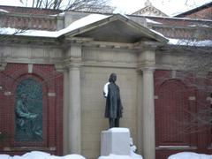 Statue of Henry Ward Beecher at Plymouth Church covered in snow with orange street sign in foreground