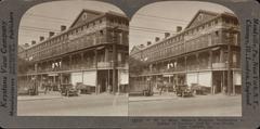 1929 stereo card view of Lower Pontalba Building at the corner of Decatur and St. Ann Street in New Orleans