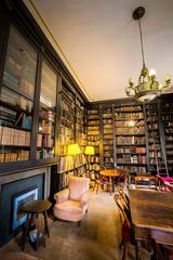 Reading room interior of The Portico Library in Manchester with wooden shelves filled with books and classic architectural design
