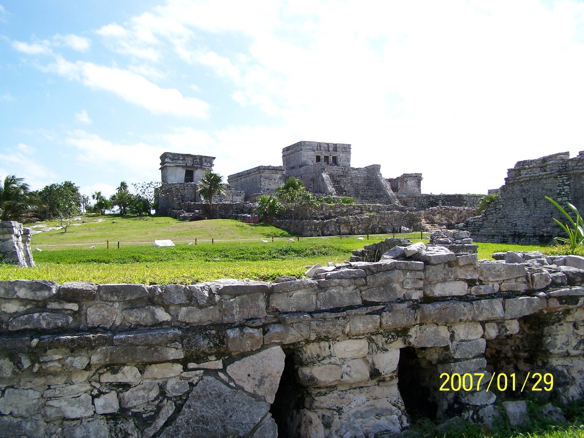 Courtyard of Tulum Ruins with ancient stone structures and greenery
