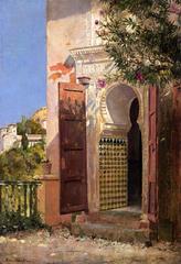 Ornate Moorish doorway at Alhambra with intricate tilework and carvings