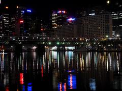 Sydney Harbour at night with city lights and reflections on water