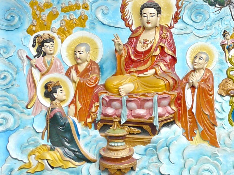 Amitabha Buddha blessing a female devotee relief at Quan Am Pagoda in Ho Chi Minh City