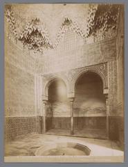 Interior view of the Sala de Abencerrajes at the Alhambra palace in Granada, showcasing intricate Moorish architectural details