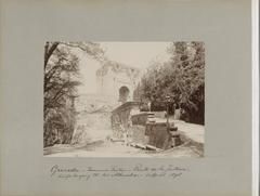 Roman fountain and the Puerta de la Justicia at an entrance of the Alhambra in Granada