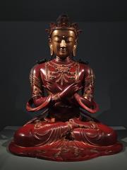 Lacquered and gilt wooden sculpture of Vajradhara, a Buddhist deity, inlaid with semiprecious stones and glass from Qing dynasty China