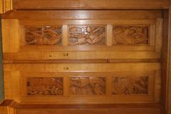 Wooden carved door of the rare book room at Radcliffe Science Library featuring wood panels with portraits of famous scientists