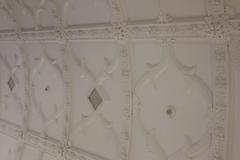 White ornate ceiling detail at Radcliffe Science Library in Oxford UK