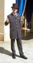 Porter of a luxury hotel in Munich giving a thumbs up
