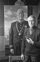 Painter Carel Willink standing in front of his portrait painting of Mayor Joost Johannes Gerardus Boot of Hilversum