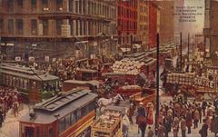 Busy urban street scene at Dearborn and Randolph Streets with people and vehicles