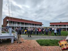 Fort McHenry Guard playing fife and drums during a historic reenactment with rangers in uniform and spectators