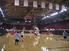 Interior view of Reynolds Coliseum with basketball court and seating areas