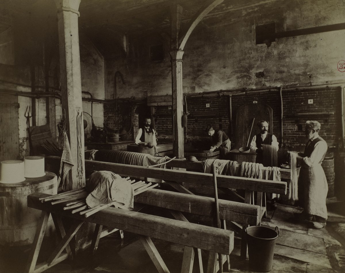 Vintage photograph of the Gobelins manufactory workshop in Paris showing workers and traditional tapestry tools