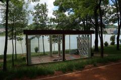 Pavilion in the Grand Park of Tirana surrounded by lush green trees and open grassy area