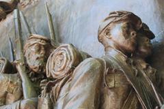 Close up of three African American soldiers marching in step from the Robert Gould Shaw and Massachusetts 54th Regiment Memorial