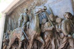 Statue of Robert Gould Shaw on horseback leading African American soldiers of the Massachusetts 54th Regiment with an allegorical angel figure above