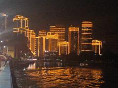 Night view of illuminated Rockwell Center buildings from Hulo, Mandaluyong City across Pasig River