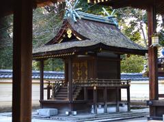 Hirano Shrine in Kyoto, Japan with traditional red torii gates and lush greenery