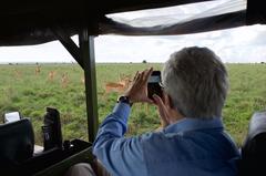 U.S. Secretary of State John Kerry photographing impalas in Nairobi National Park