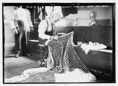 Person repairing a tennis net at Sailor's Snug Harbor