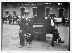 Black and white photo of an elderly man and woman sitting on a garden bench at Sailor's Snug Harbor
