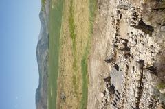 Basalt-paved cult site at the transition between Upper and Lower City of ancient Hazor with viewpoint of city ruins