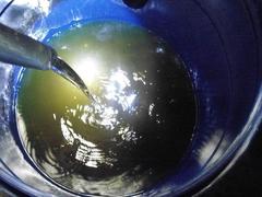 CBP officers inspecting a vehicle's gas tank for liquid methamphetamine