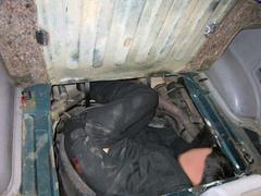 US Customs and Border Protection officers discovering a person concealed in a spare tire compartment of an SUV at San Ysidro border crossing
