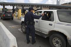 U.S. Customs and Border Protection officer inspecting vehicles at San Ysidro border crossing