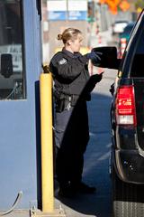 Border crossing at San Ysidro with vehicles and pedestrians under a large structure
