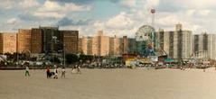 Coney Island viewed from the beach with amusement rides and buildings