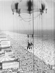 Parachute Ride attraction at Steeplechase Park in 1959 with people enjoying the ride