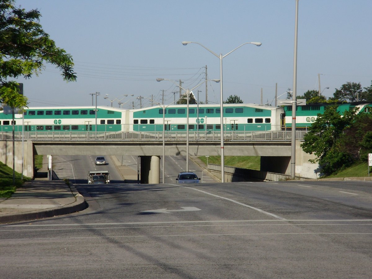 Westbound GO train on Lakeshore East line crossing St. Clair Avenue West entering Scarborough GO Station