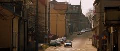 Street view of Ulica Roosevelta in Mrągowo with buildings and cars