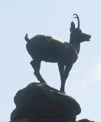 Stone statue of a chamois on a rock in Karlovy Vary