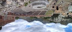 Ancient Anfiteatro di Taormina amphitheater with Mount Etna in the background