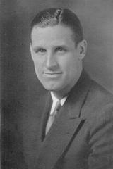 Portrait of Missouri football coach Don Faurot wearing a suit and tie