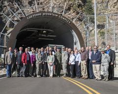 10th Air Force Civilian Leader group photo with members standing outdoors in front of aircraft
