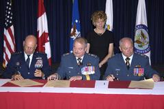 Gen. Gene Renuart, Lt.-Gen. Rick Findley, and Lt.-Gen. Charlie Bouchard signing appointment orders for NORAD deputy commander at Peterson Air Force Base 2007
