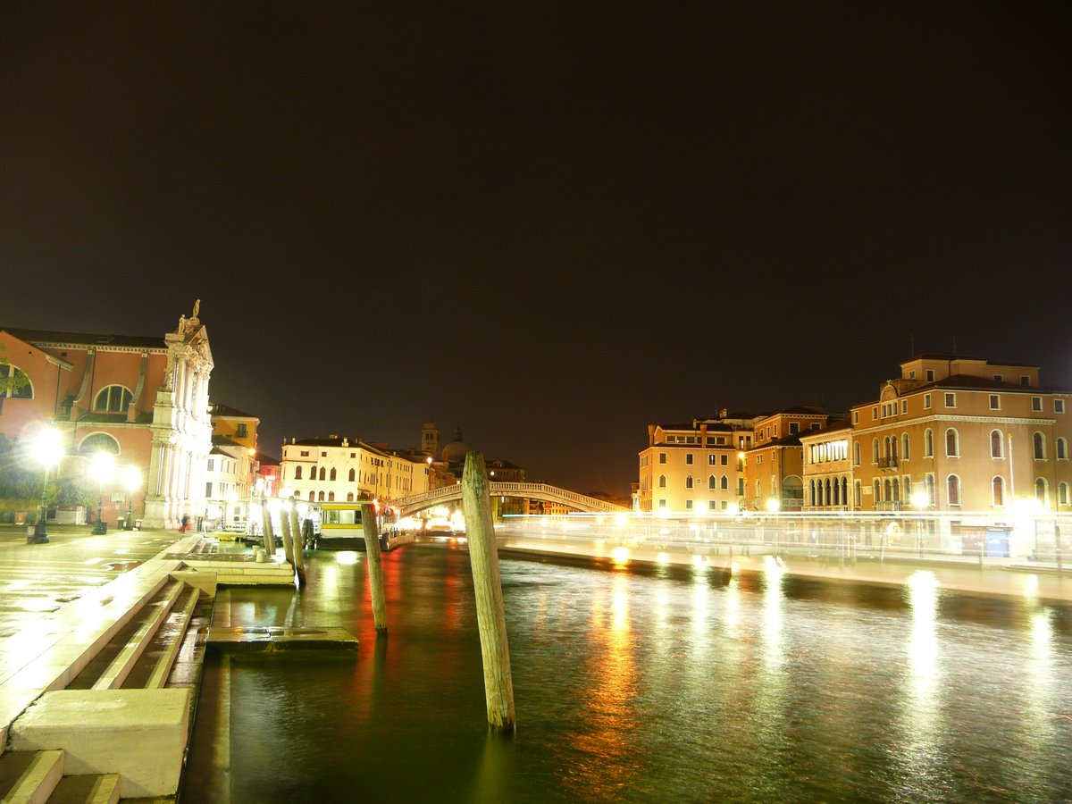 Night view of Canal Grande near Santa Lucia railway station with illuminated buildings and reflections on water