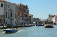 Grand Canal in Venice with Riva de Biasio street and vaporetto stop, Ponte degli Scalzi bridge and Santa Maria degli Scalzi church in the background