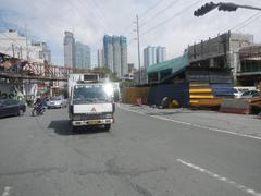 Shaw Boulevard intersection in Pasig City with cars and high-rise buildings during daytime