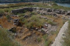 Chalcolithic sanctuary archaeological site with ancient stone structures and lush greenery