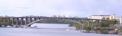 Tranebergsbron bridge in Stockholm over water with cityscape in the background