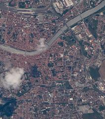 Aerial view of Pisa, Italy from the ISS showing the Leaning Tower of Pisa at Piazza dei Miracoli, Arno River, Pisa San Rossore railway station, Pisa Centrale, and surrounding old town rooftops during ISS Expedition 65