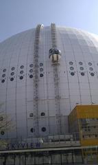 Ericsson Globe SKYVIEW gondolas ascending beside the spherical Ericsson Globe arena in Stockholm