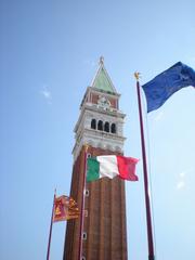 Campanile di San Marco bell tower with flags in Venice Italy