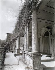 Vine covered porch of St. Mark's Church with carved columns flanking the doorway