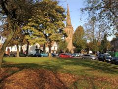 Kings Norton Green and St Nicolas Church surrounded by autumnal leaves